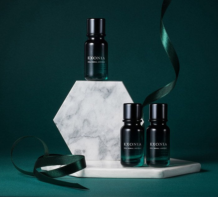 EXONIA Cell Signal Ampoule Serum bottles on marble