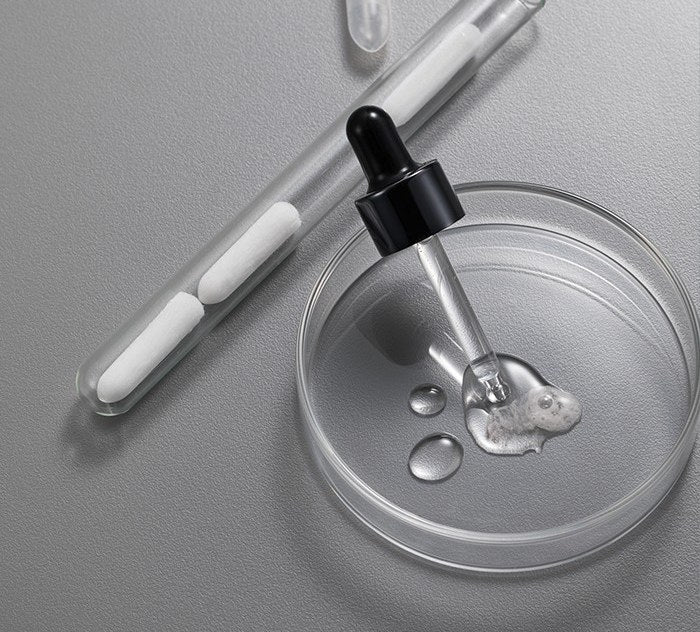 EXONIA serum texture on a dropper